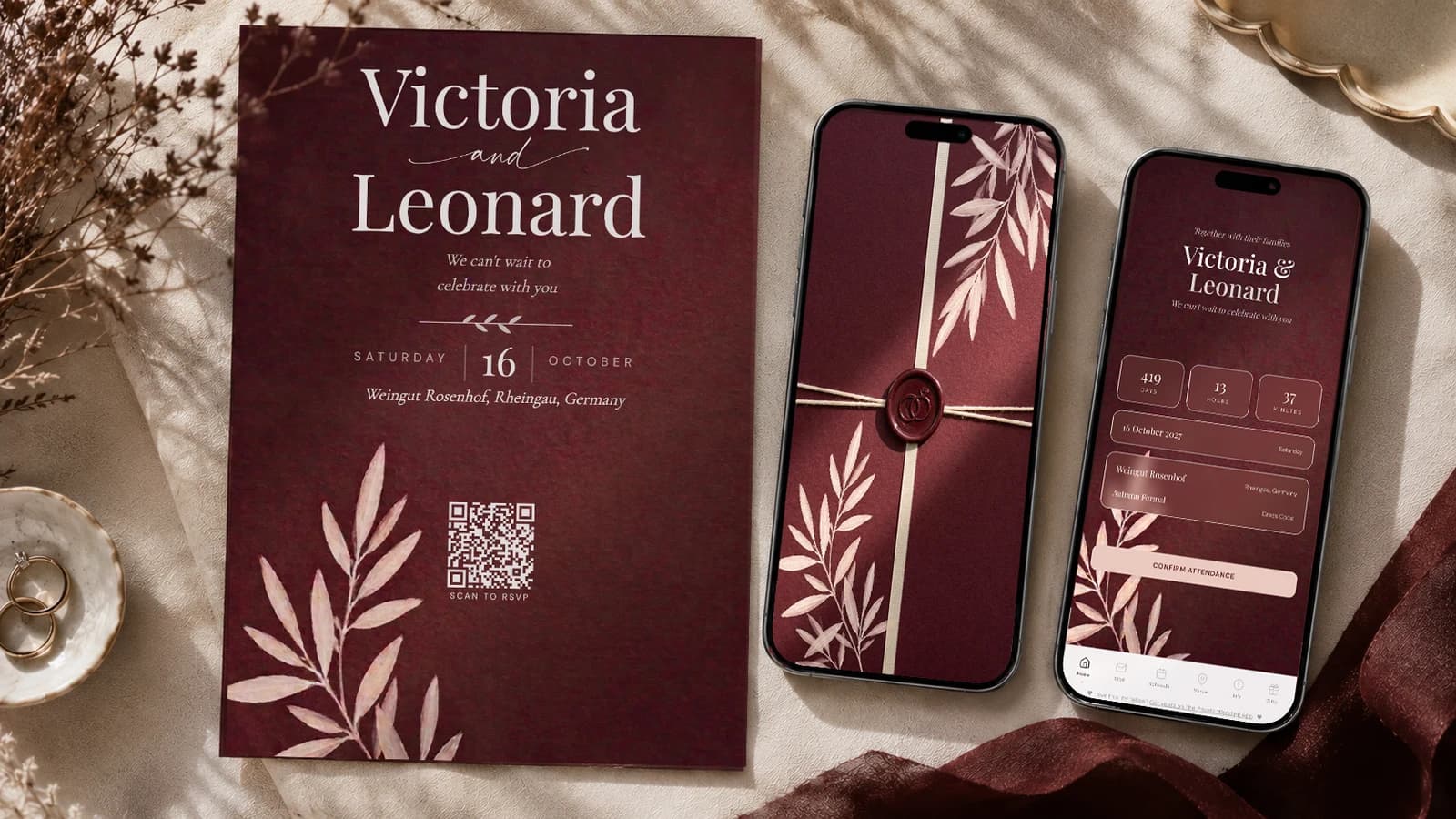 Burgundy wedding invitation suite on cream linen with dried flowers: printed deep wine invitation card with the couple's names, date, venue and scan-to-RSVP QR code, a phone showing the wax-sealed burgundy envelope with cream ribbon, and a phone showing the digital invitation cover with countdown and Confirm Attendance button