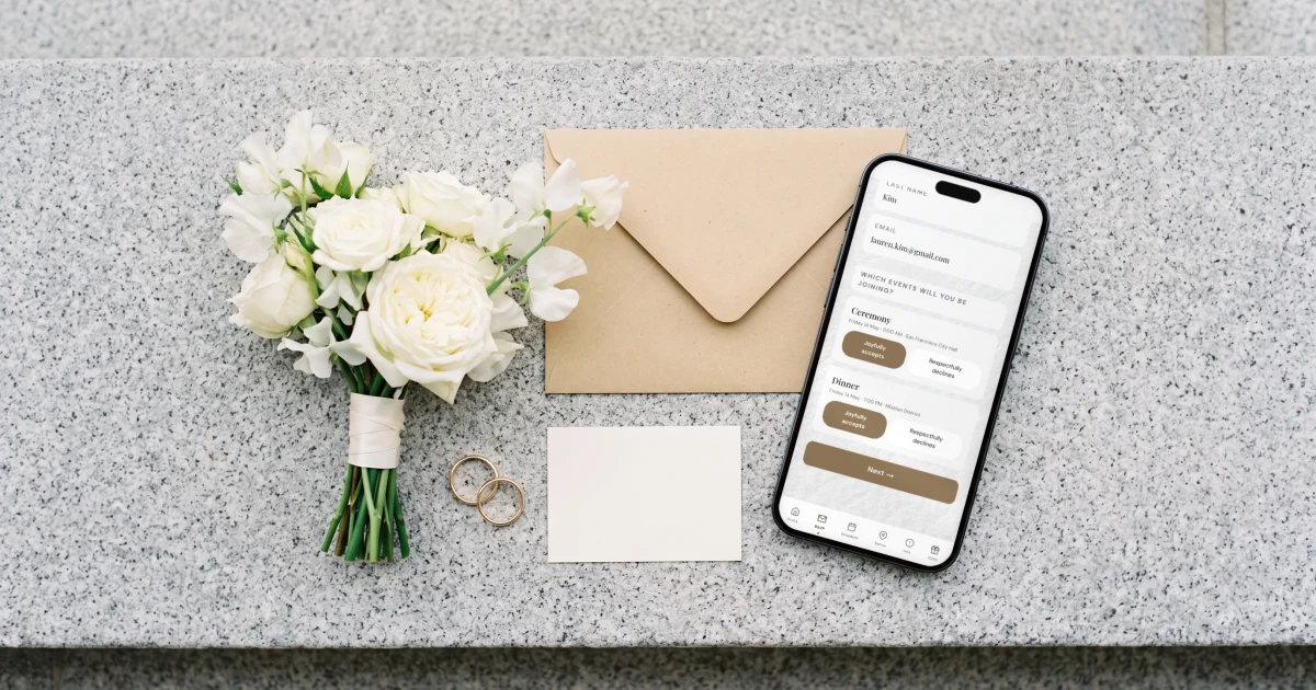 Courthouse wedding: a phone shows the RSVP for the ceremony and dinner beside a marriage license envelope and a small bouquet