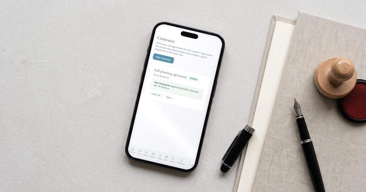 Wedding planner contract signed online: a phone shows a planning agreement signed by the couple with the signer's name, time and IP recorded, beside a linen folder and fountain pen