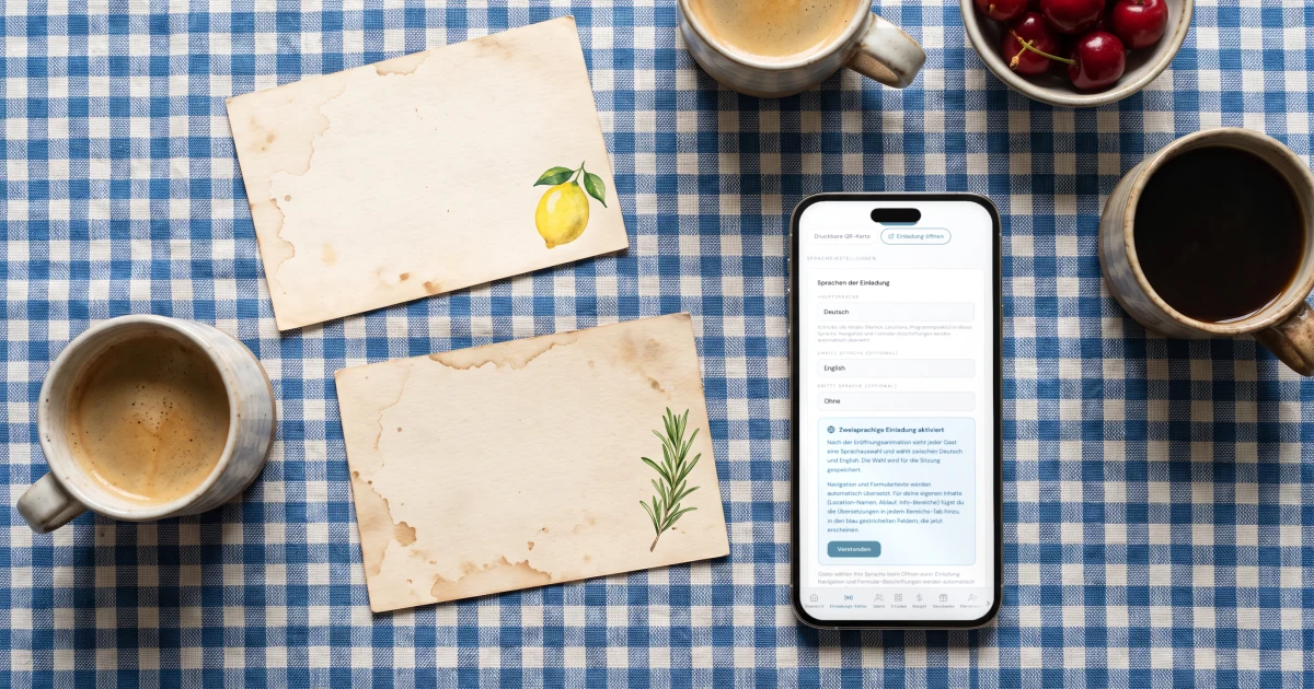 Zweisprachige Hochzeit planen: ein Handy zeigt die Spracheinstellungen der Einladung mit Deutsch und Englisch neben zwei Karten und Kaffeetassen